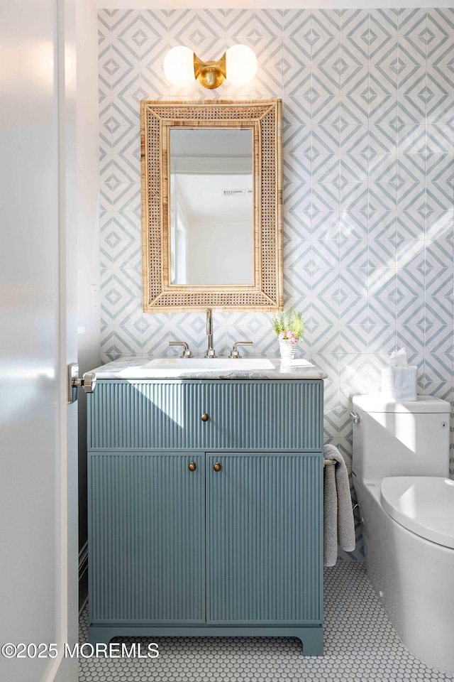 bathroom featuring tile patterned flooring, visible vents, toilet, and vanity