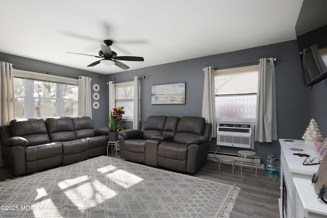 living room featuring ceiling fan, a baseboard heating unit, cooling unit, and wood finished floors