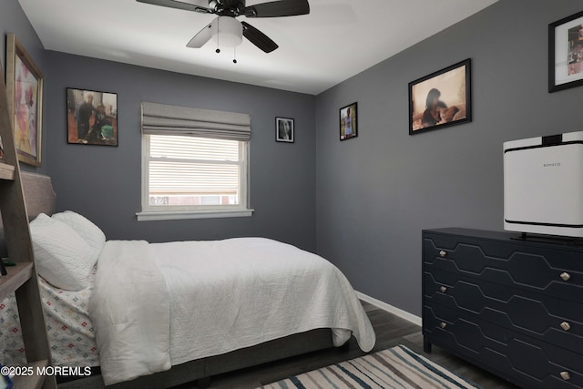 bedroom with ceiling fan, baseboards, and wood finished floors