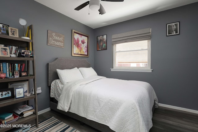 bedroom featuring ceiling fan, baseboards, and wood finished floors