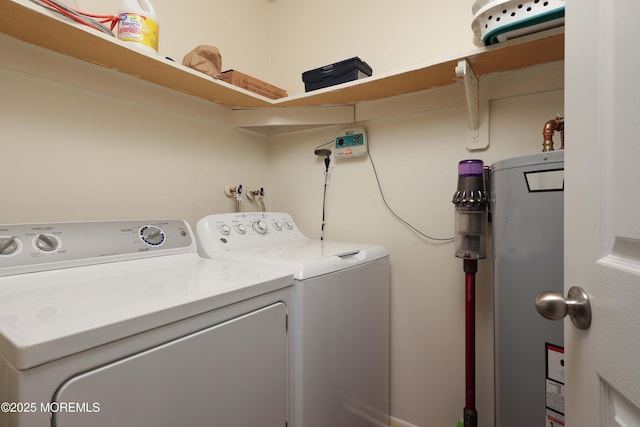 washroom featuring laundry area, water heater, and washing machine and clothes dryer