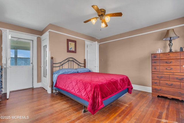 bedroom featuring hardwood / wood-style floors, baseboards, and ceiling fan