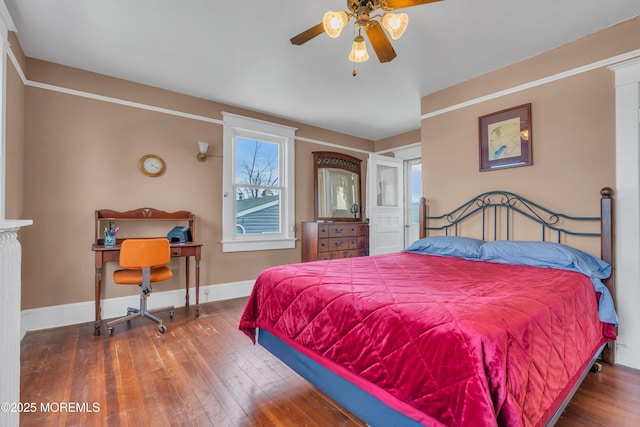 bedroom with a ceiling fan, baseboards, and wood-type flooring