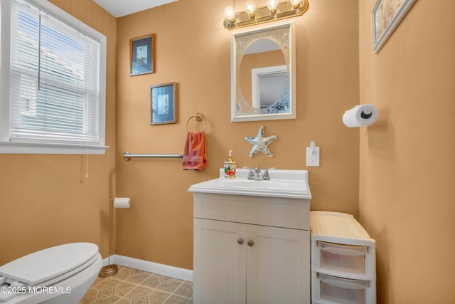 bathroom with tile patterned floors, baseboards, toilet, and vanity