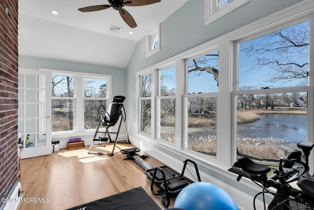 exercise area with vaulted ceiling, visible vents, a wealth of natural light, and ceiling fan