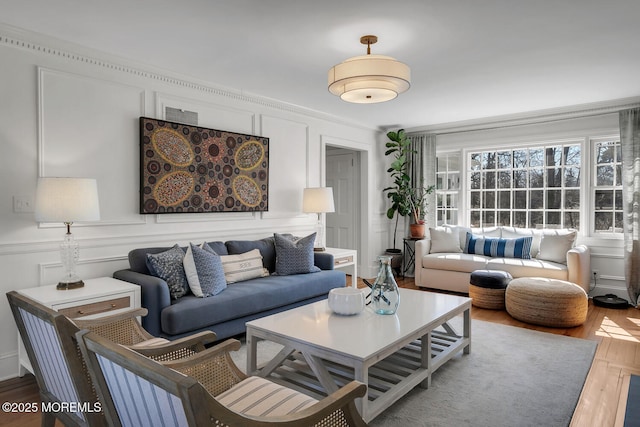 living area with a decorative wall and wood finished floors