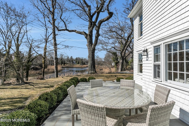 view of patio / terrace featuring outdoor dining area and a water view