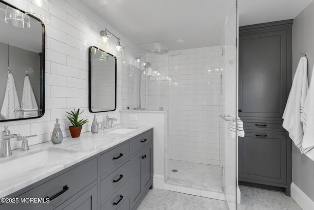 bathroom with double vanity, walk in shower, and a sink