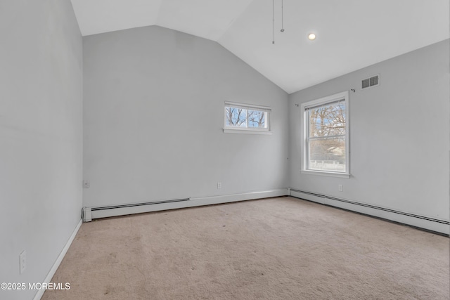 empty room with visible vents, carpet flooring, baseboards, and lofted ceiling