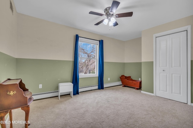 unfurnished room featuring baseboards, visible vents, a baseboard radiator, ceiling fan, and carpet flooring