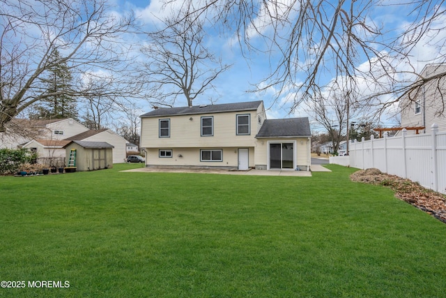 back of house with a patio, a lawn, an outdoor structure, and fence