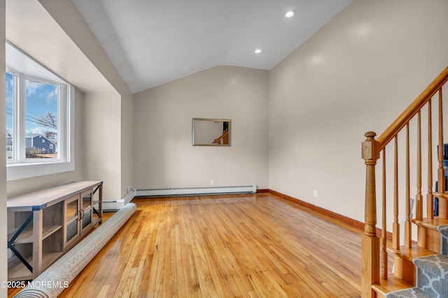 living room featuring light wood-style flooring, stairway, a baseboard heating unit, and vaulted ceiling