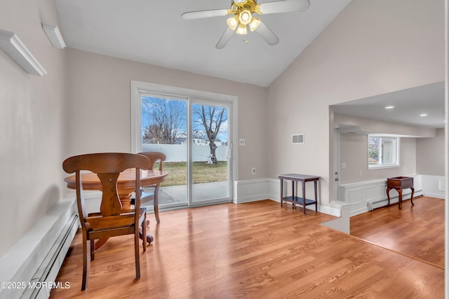 living area featuring ceiling fan, light wood-style floors, visible vents, and a baseboard radiator