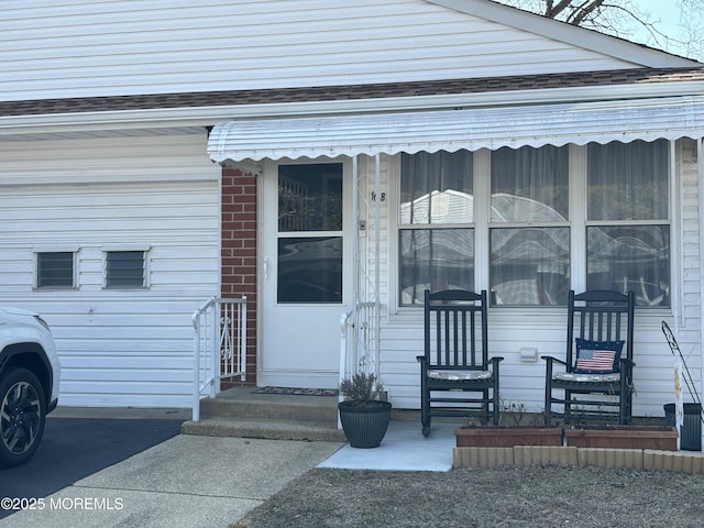 doorway to property featuring brick siding