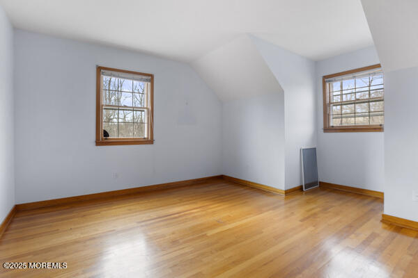 502 Monmouth Rd, West Long Branch, NJ 07764 - bonus room featuring lofted ceiling, plenty of natural light, baseboards, and light wood-type flooring