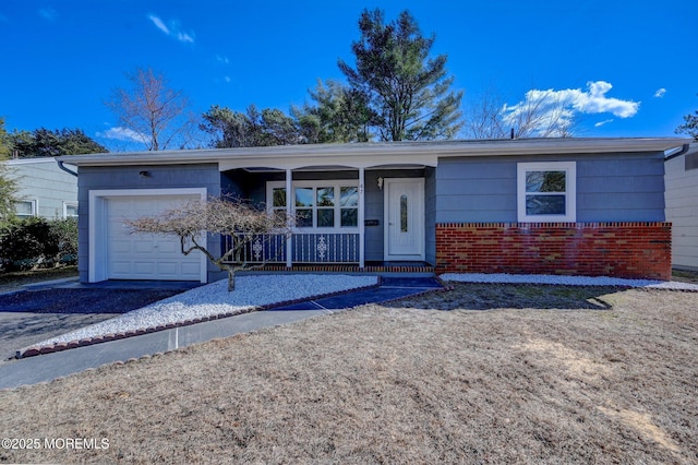 ranch-style home featuring a porch, a garage, brick siding, and driveway