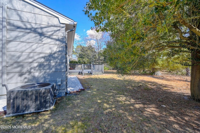 view of yard with a deck and cooling unit