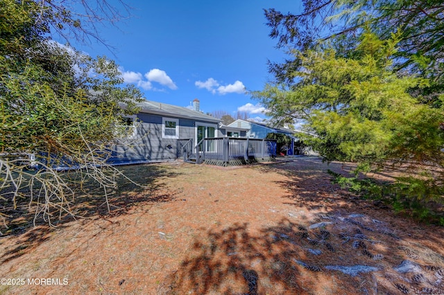 back of property with a wooden deck