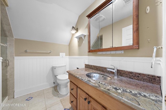 full bathroom with a wainscoted wall, lofted ceiling, a stall shower, tile patterned floors, and vanity