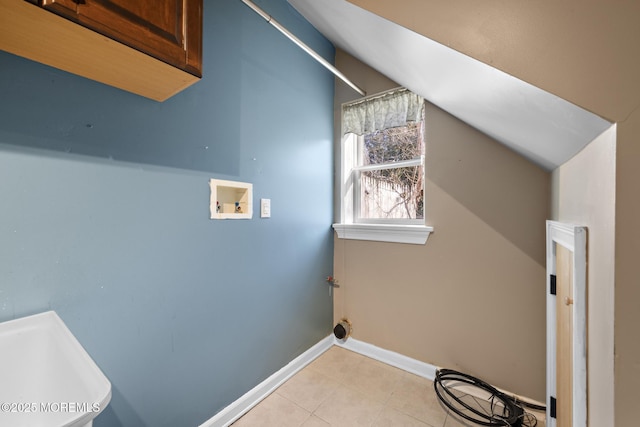 laundry room featuring light tile patterned flooring, cabinet space, baseboards, and washer hookup