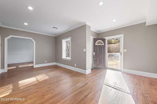 entrance foyer with visible vents, baseboards, recessed lighting, ornamental molding, and light wood-type flooring