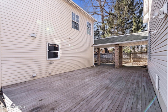 wooden terrace featuring fence