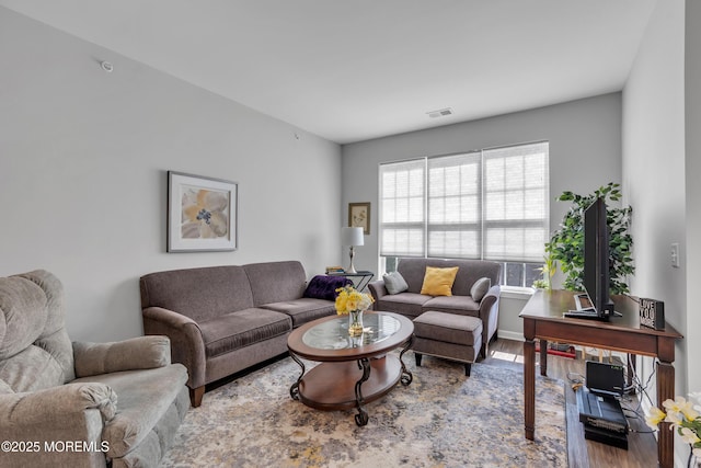 living room featuring wood finished floors and visible vents