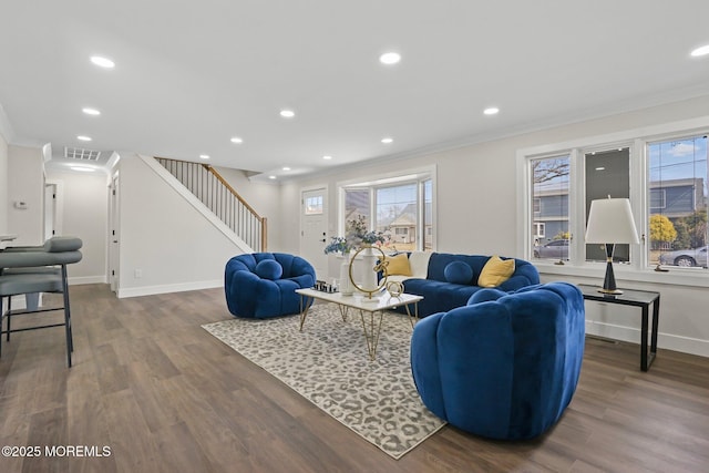 living area with visible vents, crown molding, baseboards, stairs, and wood finished floors