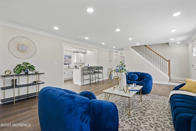 living area featuring stairs, crown molding, recessed lighting, and wood finished floors