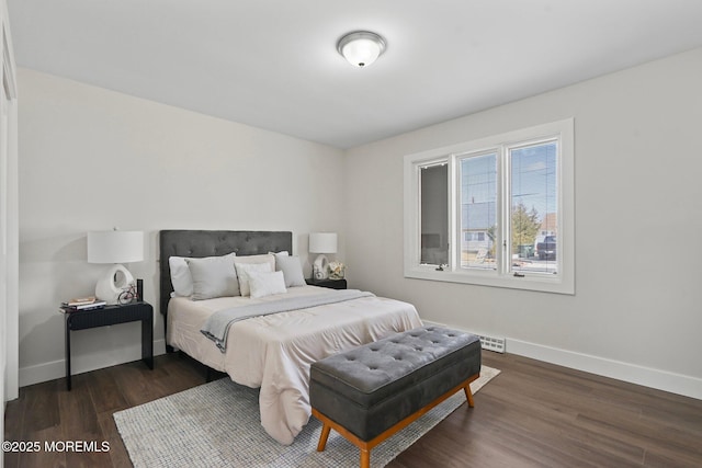 bedroom featuring dark wood-style floors and baseboards