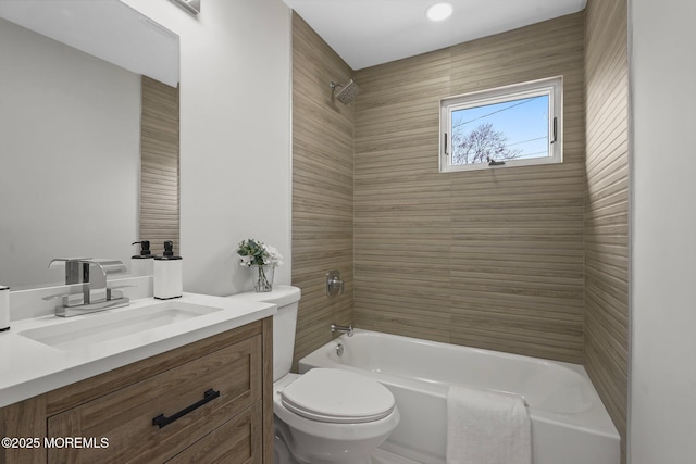 bathroom featuring vanity, toilet, and  shower combination