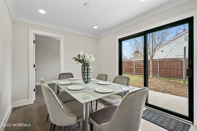 dining area featuring recessed lighting, crown molding, baseboards, and wood finished floors