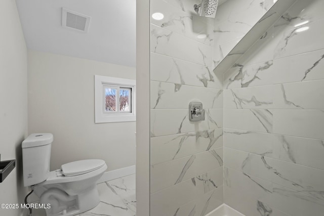 full bath featuring visible vents, toilet, marble finish floor, a tile shower, and baseboards