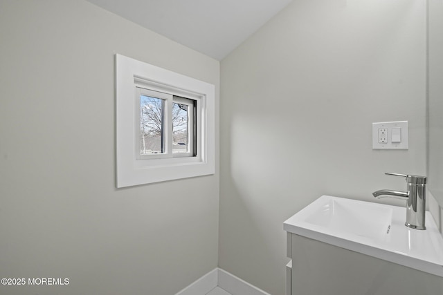 bathroom featuring baseboards and vanity