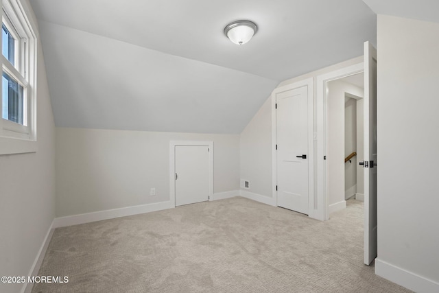 bonus room with vaulted ceiling, visible vents, baseboards, and carpet floors