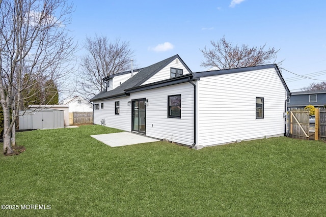 rear view of house with a lawn, a patio, a fenced backyard, a storage shed, and an outdoor structure