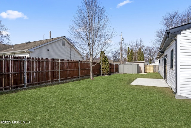 view of yard featuring a fenced backyard, a storage shed, and an outdoor structure