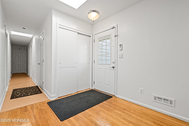 entrance foyer with visible vents, wood-type flooring, and baseboards