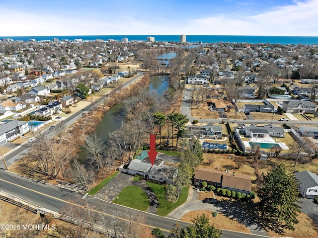 bird's eye view featuring a water view and a residential view