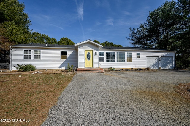 view of front of home with gravel driveway and an attached garage