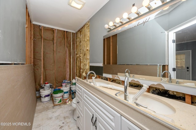 bathroom with concrete floors, vanity, and crown molding