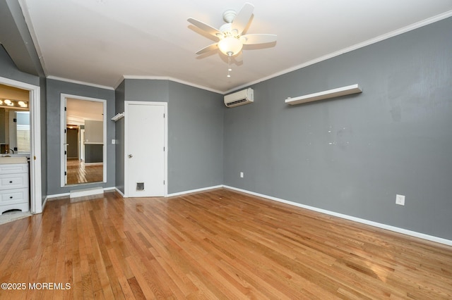 unfurnished bedroom featuring baseboards, light wood finished floors, ceiling fan, ornamental molding, and a wall mounted air conditioner