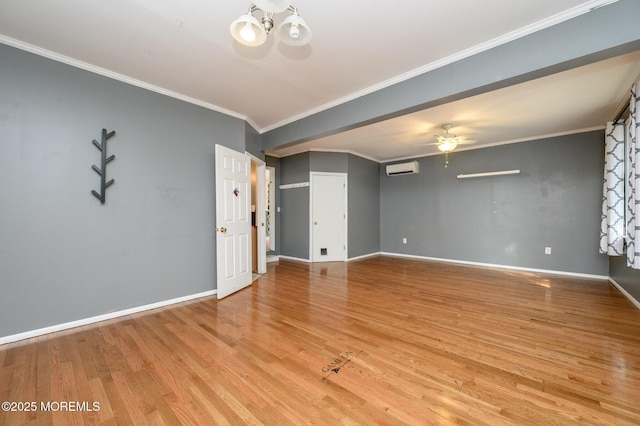 empty room with crown molding, light wood-style flooring, ceiling fan with notable chandelier, and baseboards