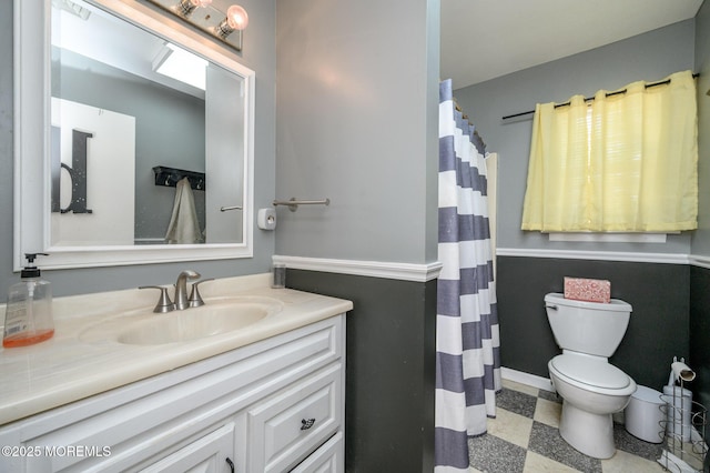 bathroom with tile patterned floors, toilet, vanity, and a shower with curtain