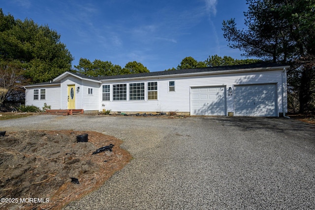 ranch-style home with an attached garage, driveway, and crawl space