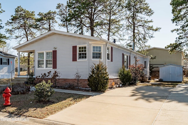 manufactured / mobile home with an outbuilding and a shed