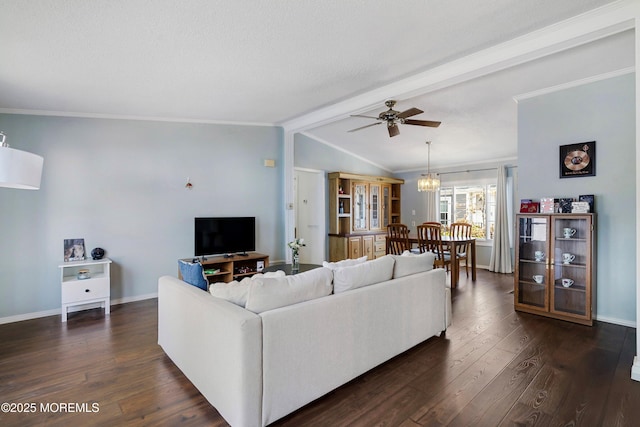 living area featuring baseboards, lofted ceiling with beams, ornamental molding, ceiling fan with notable chandelier, and dark wood-style flooring