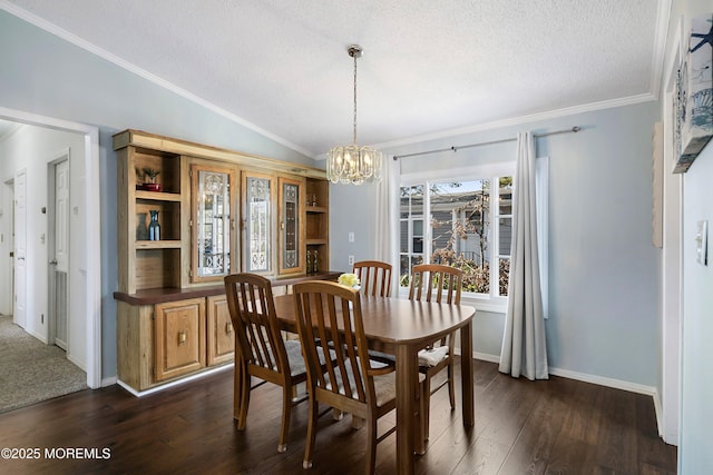 dining area featuring lofted ceiling, a textured ceiling, dark wood finished floors, and crown molding