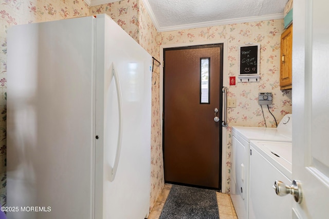 interior space with wallpapered walls, ornamental molding, light tile patterned flooring, independent washer and dryer, and a textured ceiling