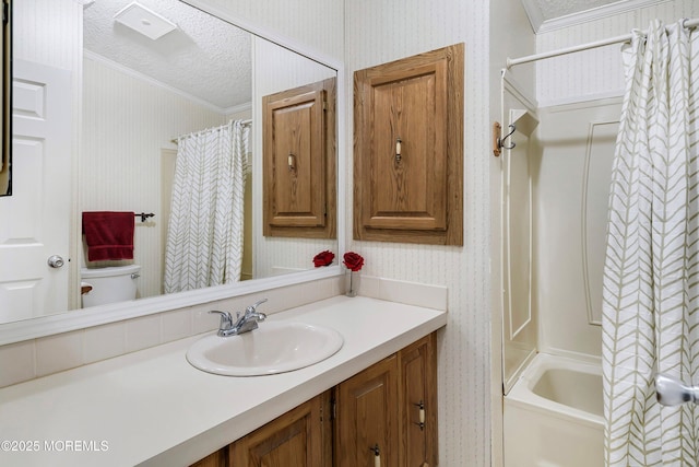 bathroom with wallpapered walls, crown molding, vanity, a textured ceiling, and shower / bathtub combination with curtain